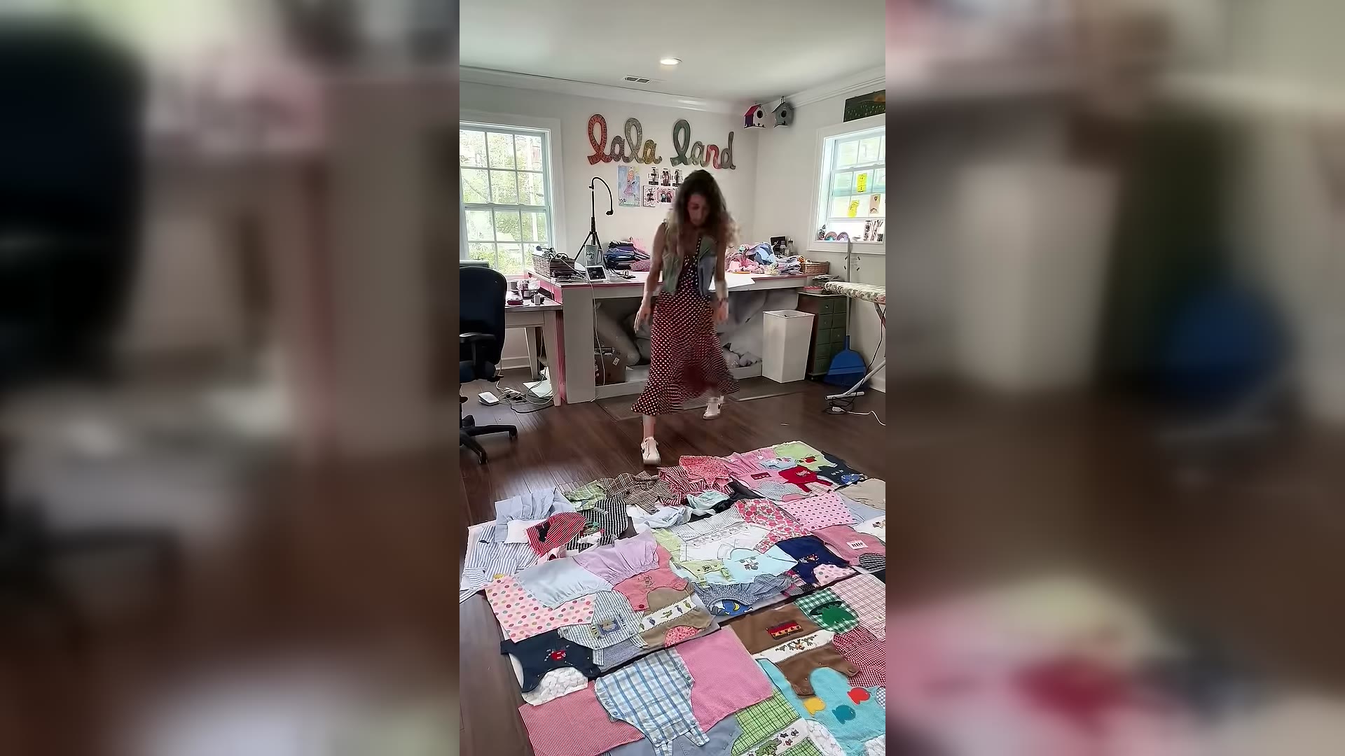 Lala laying out a baby-clothes memory quilt in her North Myrtle Beach studio.